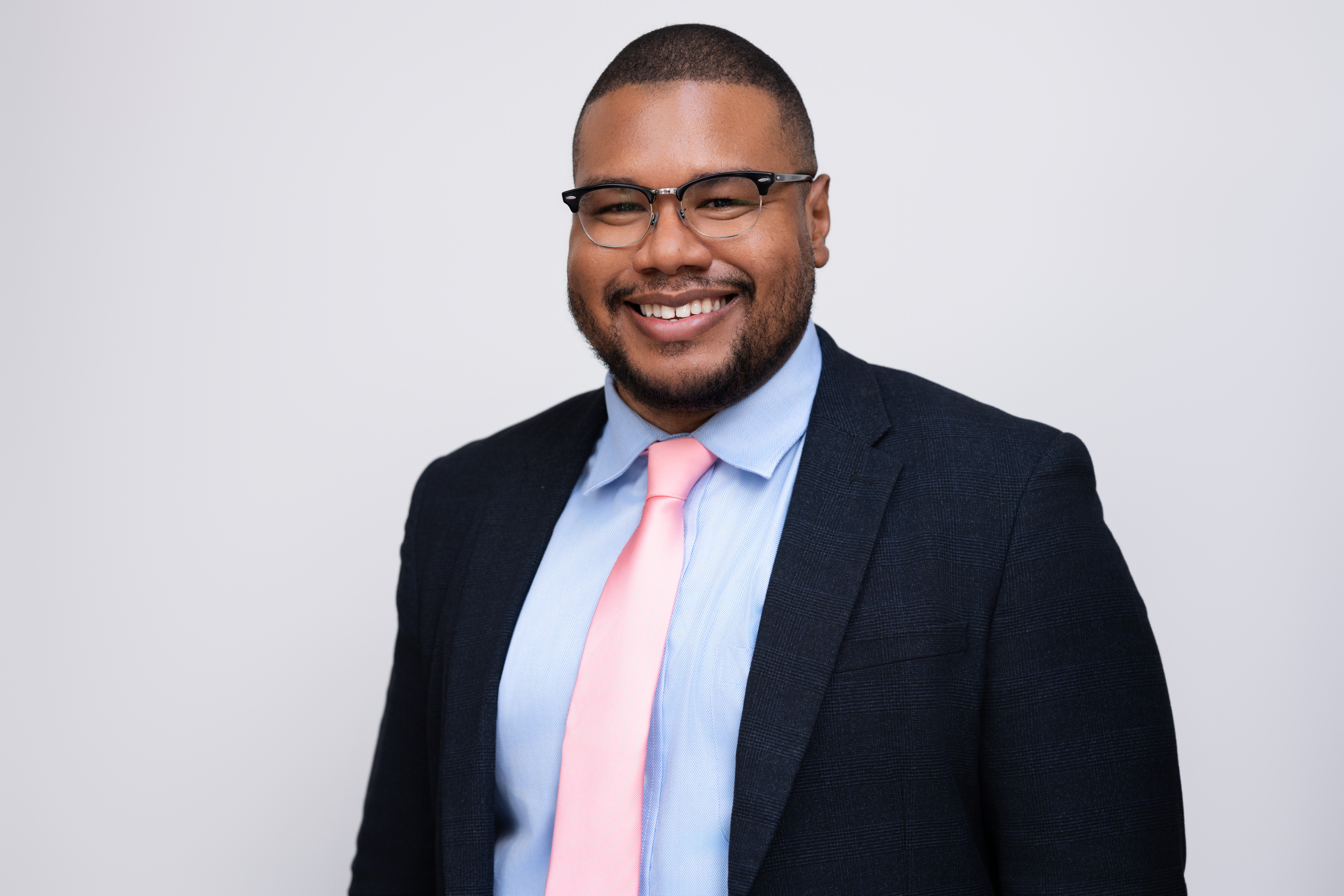 James Earl Hollywood III, founder of RISE USA, smiling in a navy suit